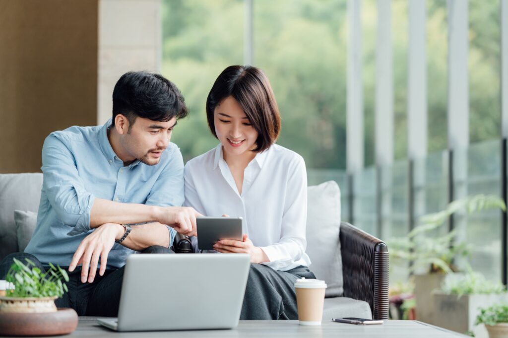 a man and woman looking at a tablet