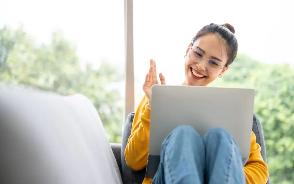 MAIN 3 a girl smiling Infront of laptop